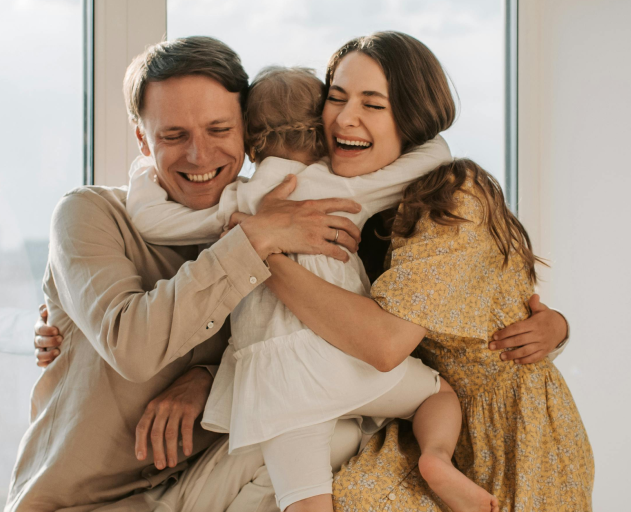 Family hugging and smiling together